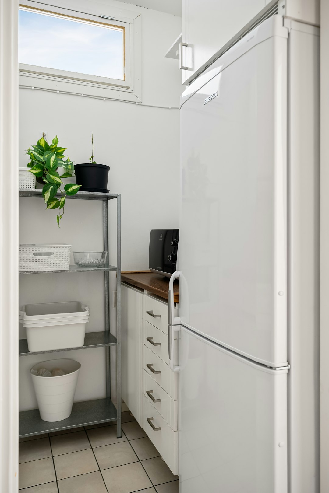 about-us a-white-refrigerator-freezer-sitting-inside-of-a-kitchen-aect53ip62u